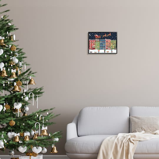 Stupell Industries Snowy Christmas Town Santa Overhead Framed Giclee Art